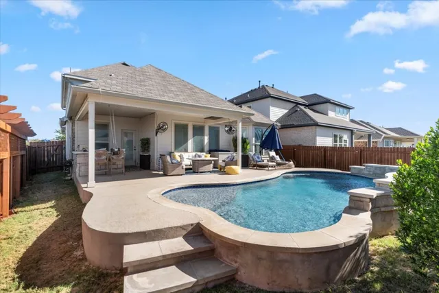 a view of a house with swimming pool and furniture
