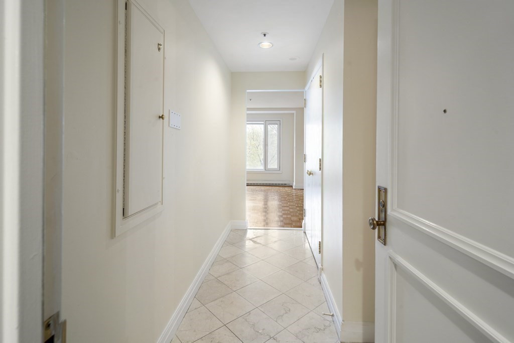 20 Rowes Wharf, Unit 503 Boston, MA 02110 - Photo 11 of 26 a view of a hallway with wooden floor and a bathroom