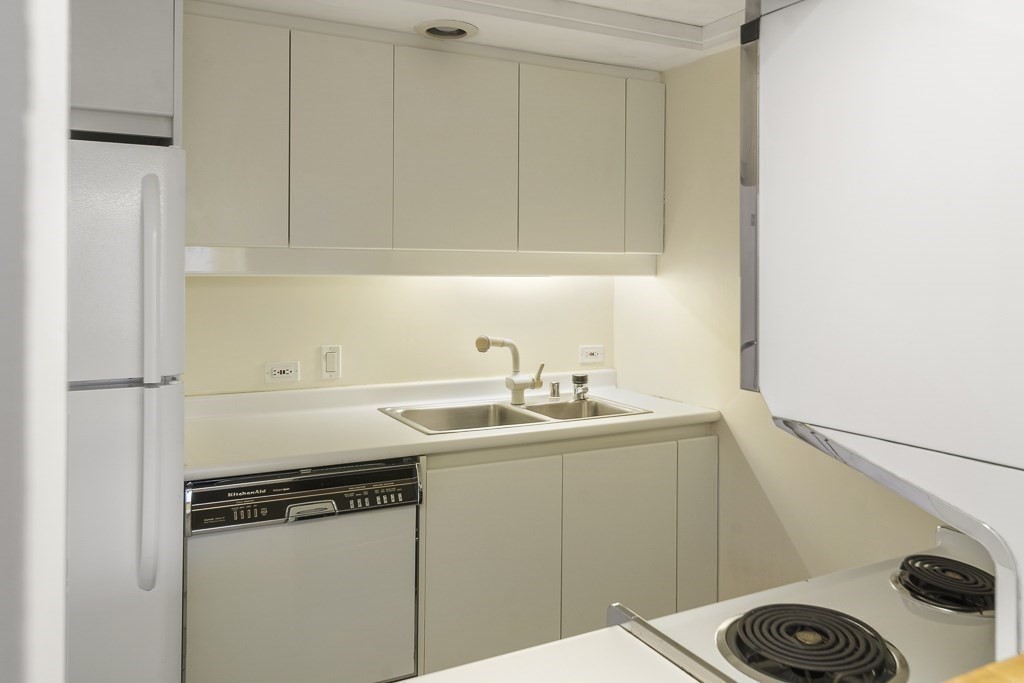 20 Rowes Wharf, Unit 503 Boston, MA 02110 - Photo 15 of 26 a kitchen with a sink a stove and cabinets