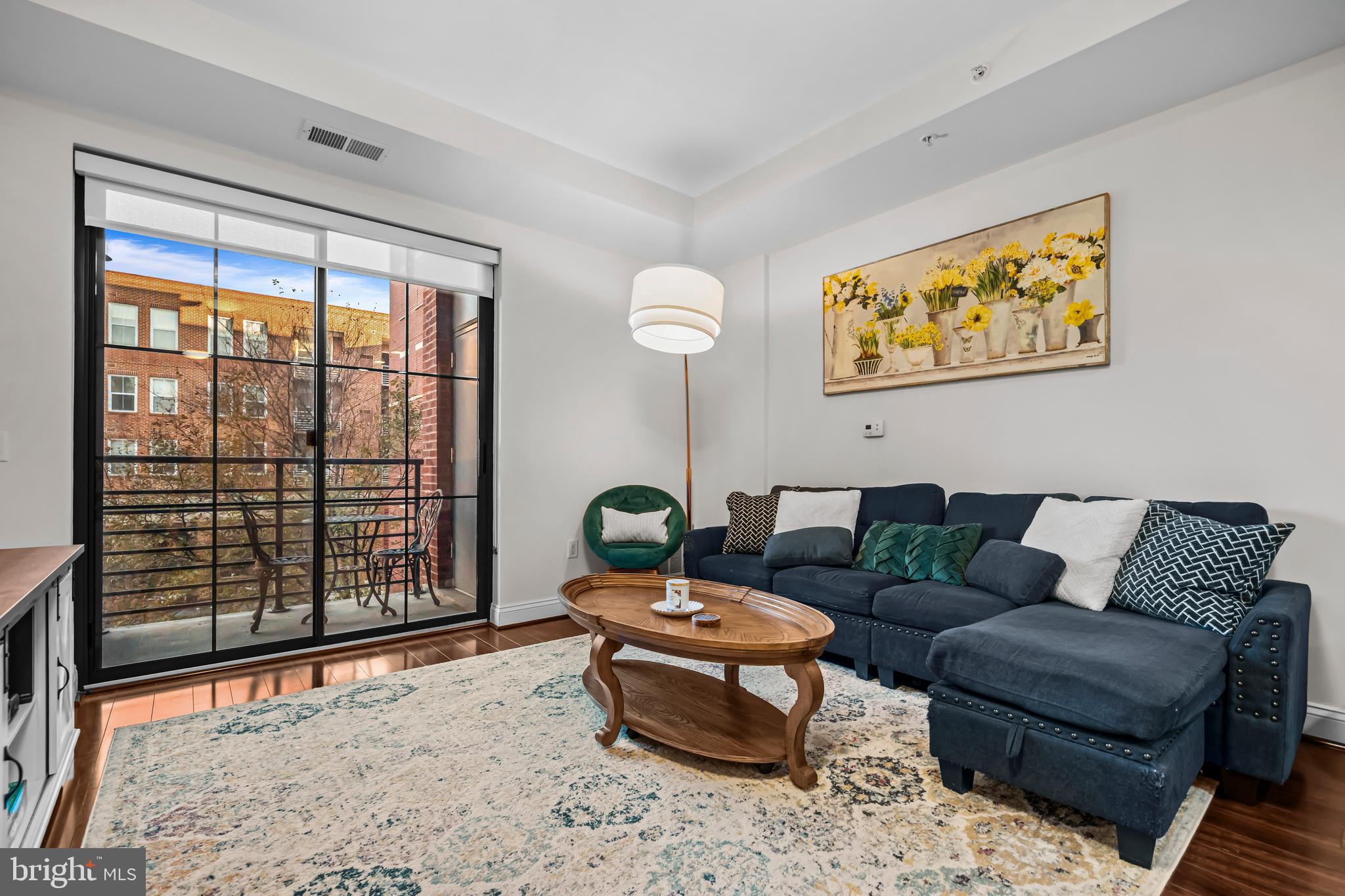 1111 Oronoco Street, Unit 326 Alexandria, VA 22314 - Photo 13 of 54 a living room with furniture and a large window