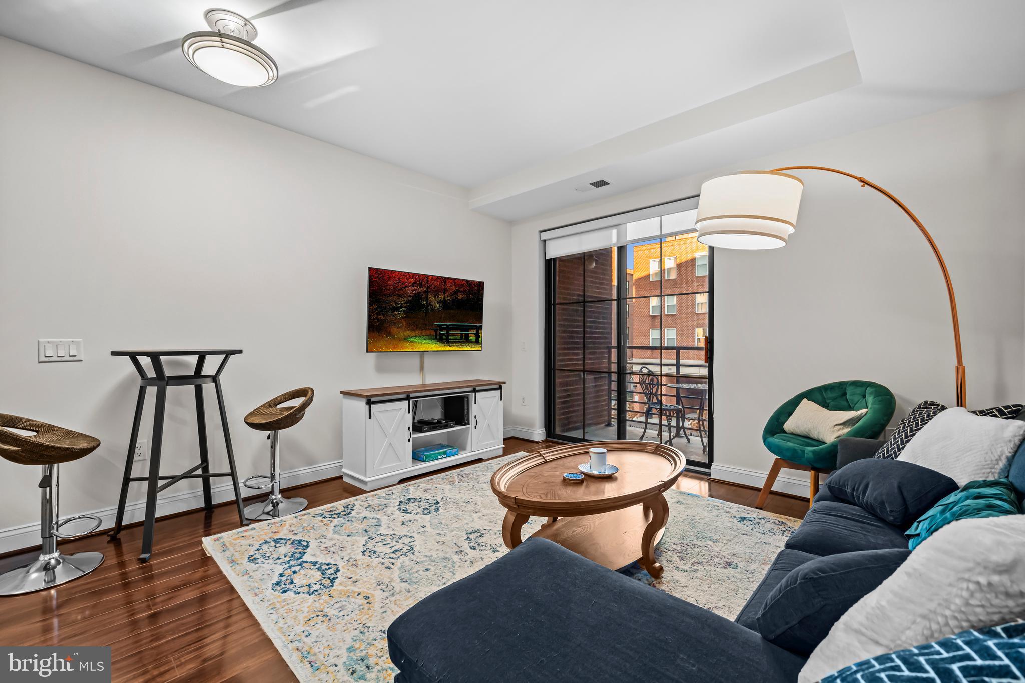 1111 Oronoco Street, Unit 326 Alexandria, VA 22314 - Photo 15 of 54 a living room with furniture and a flat screen tv