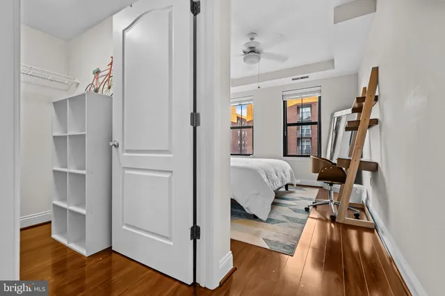 a bedroom with a bed and wooden floor