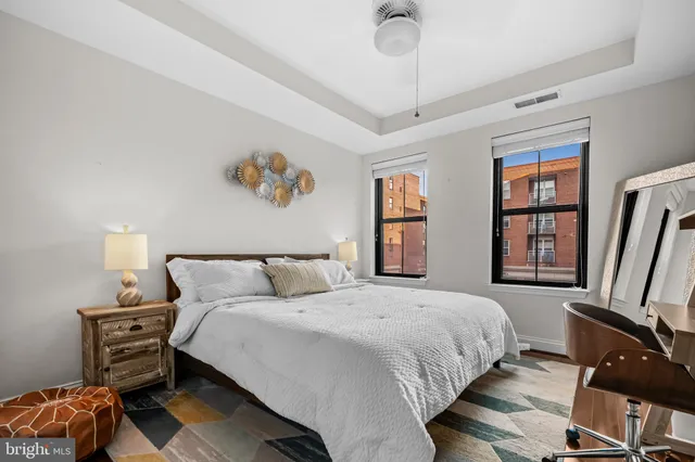 a bedroom with a bed and a large window