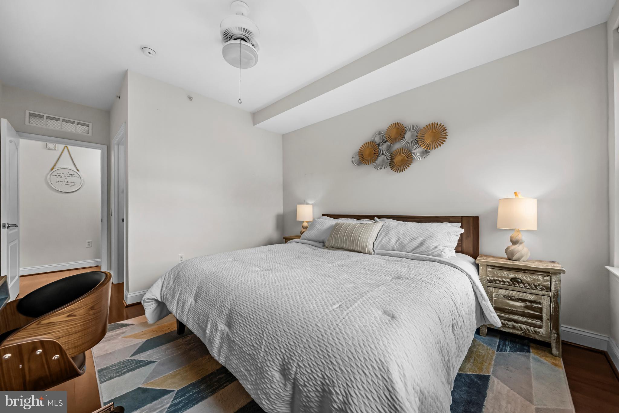 1111 Oronoco Street, Unit 326 Alexandria, VA 22314 - Photo 25 of 54 a bedroom with a bed and wooden floor