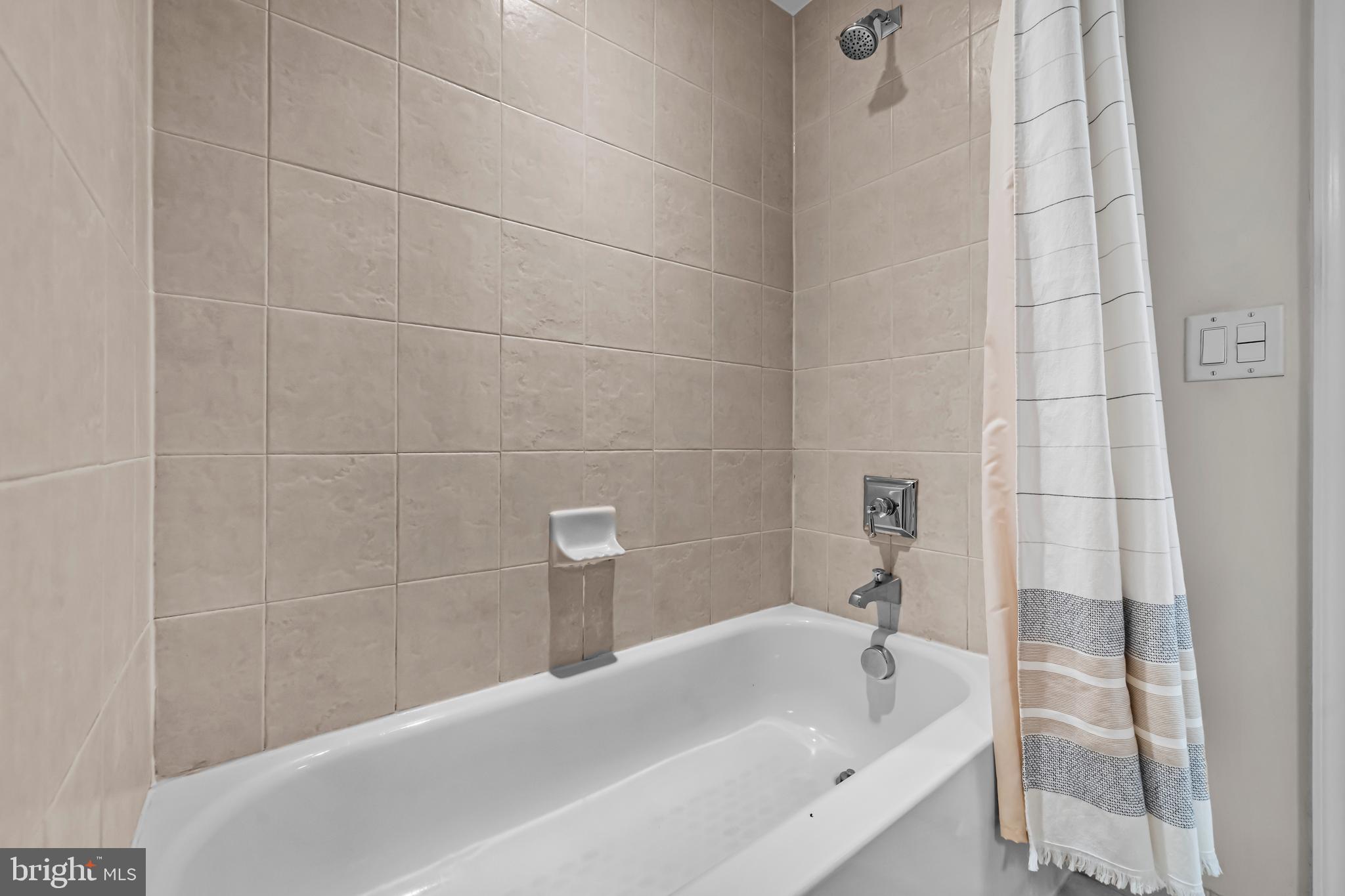 1111 Oronoco Street, Unit 326 Alexandria, VA 22314 - Photo 34 of 54 a bathroom with a tub and shower