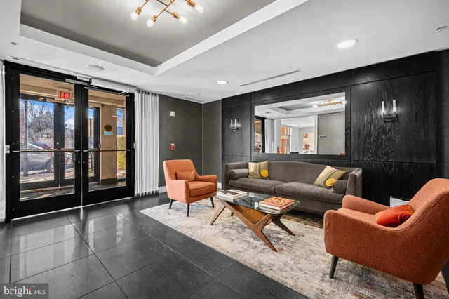 a living room with furniture and a chandelier