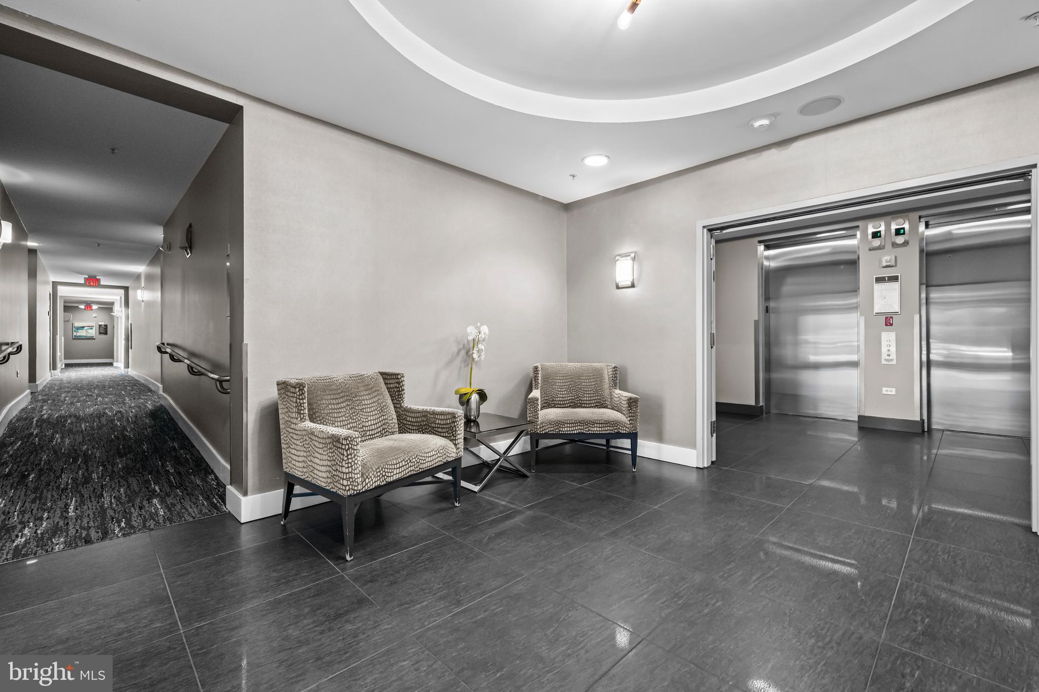 1111 Oronoco Street, Unit 326 Alexandria, VA 22314 - Photo 39 of 54 a living room with furniture and a chandelier