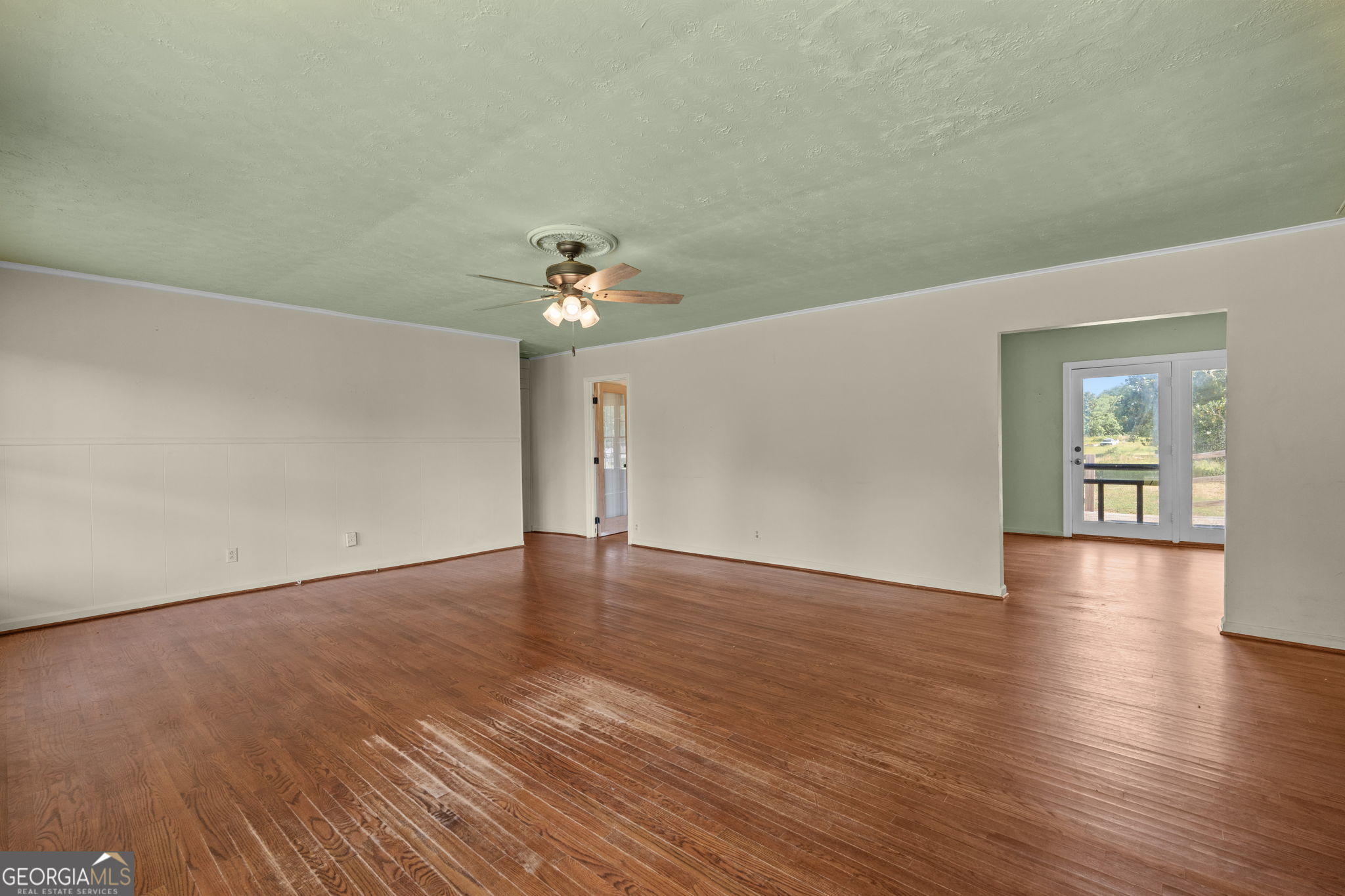 49 Frost Road Bowdon, GA 30108 - Photo 7 of 60 a view of an empty room with wooden floor and a window