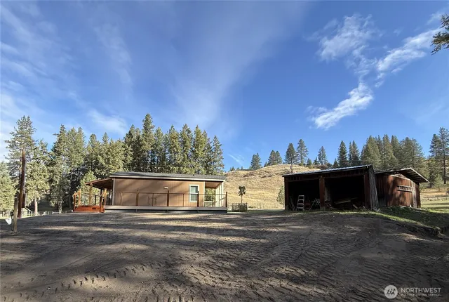 a view of a chair and table in backyard of the house