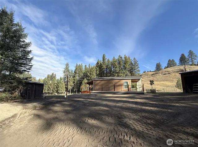 a view of a yard with large trees