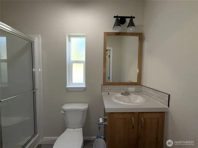 a bathroom with a sink toilet and a mirror