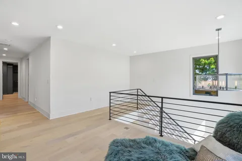 a kitchen with stainless steel appliances granite countertop a sink a stove and a wooden floors
