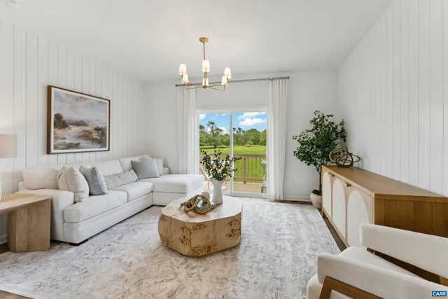 a living room with furniture and a chandelier