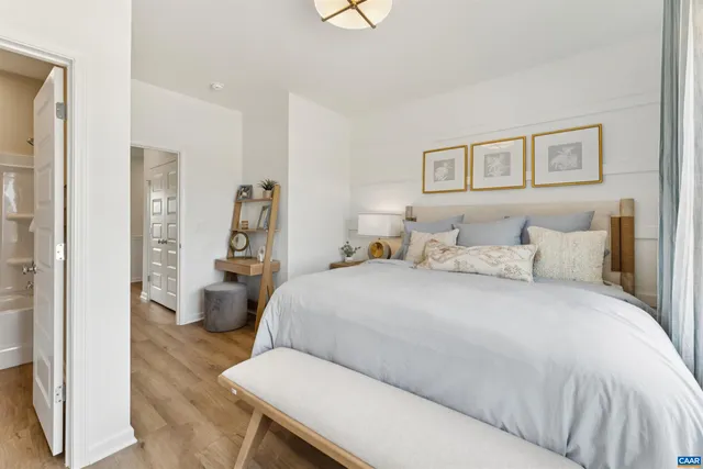 a bedroom with a bed and a painting on the wall