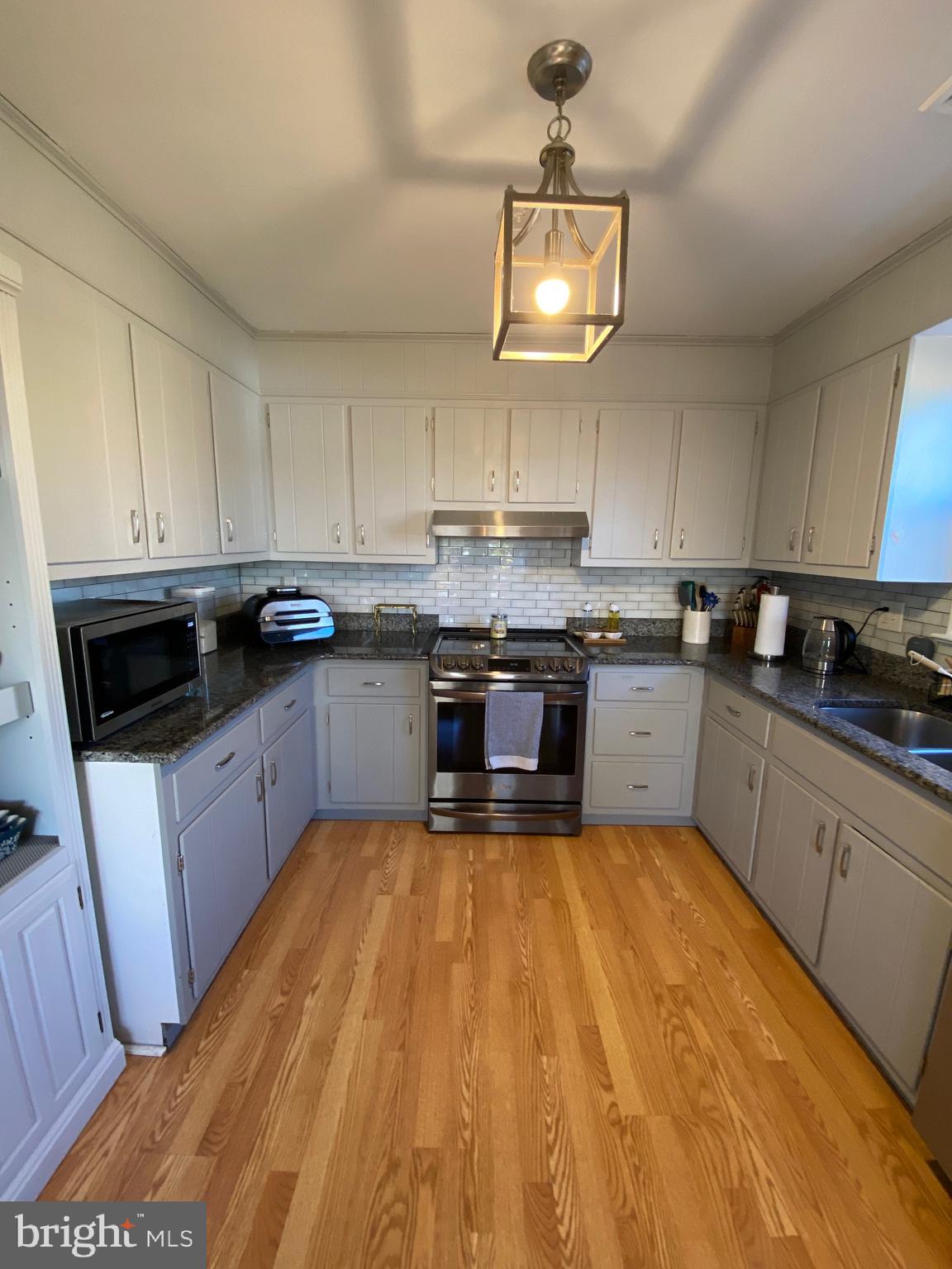 847 Rivendell Lane Pottstown, PA 19464 - Photo 11 of 41 a large kitchen with stainless steel appliances granite countertop a stove top oven a sink dishwasher and white cabinets with wooden floor