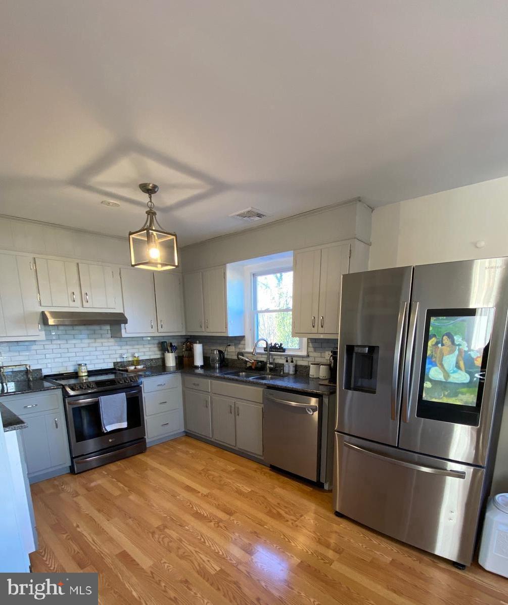 847 Rivendell Lane Pottstown, PA 19464 - Photo 13 of 41 a kitchen with stainless steel appliances granite countertop a refrigerator stove a sink dishwasher and a microwave oven