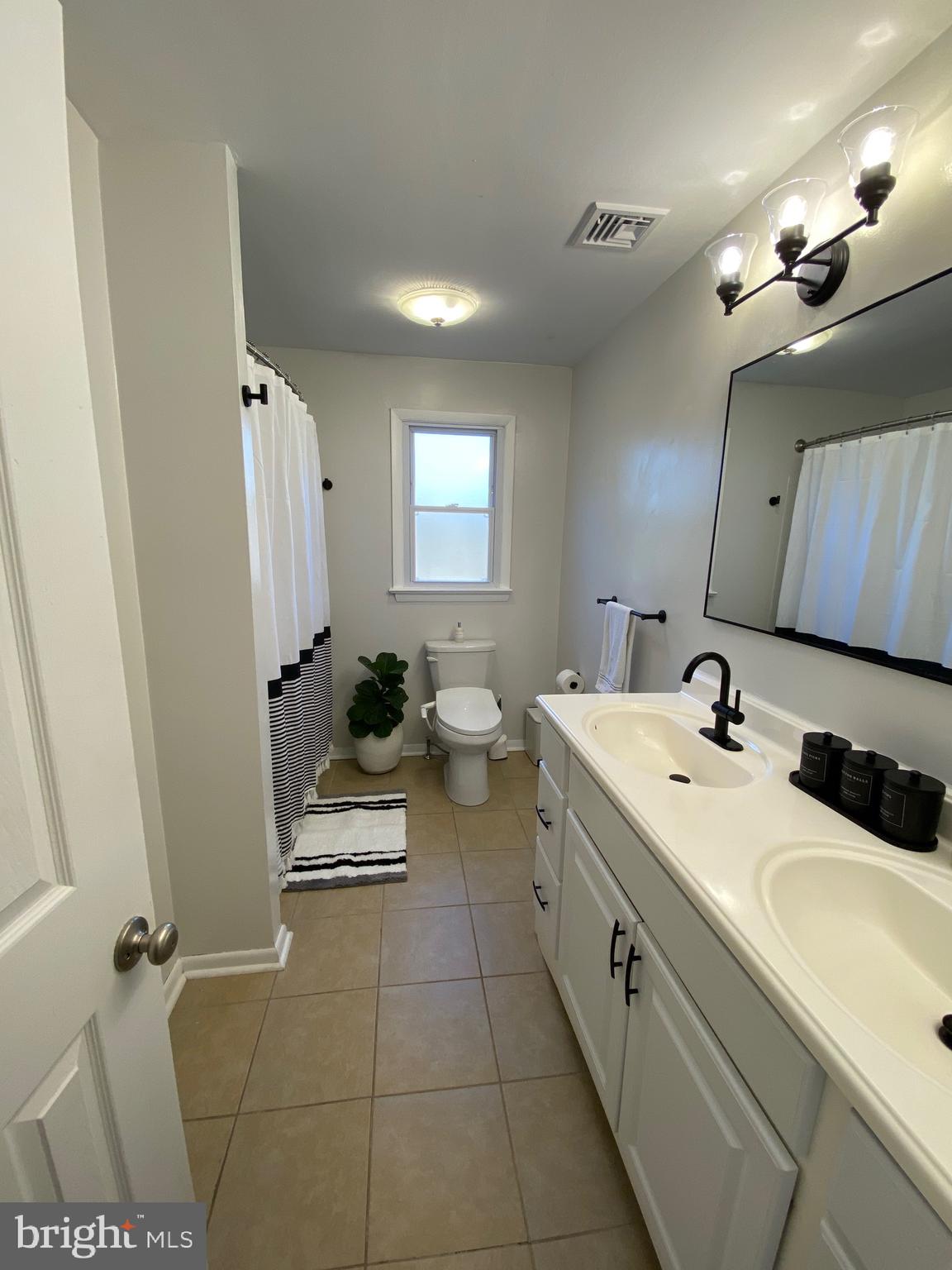 847 Rivendell Lane Pottstown, PA 19464 - Photo 14 of 41 a spacious bathroom with a double vanity sink toilet and mirror