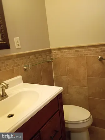a bathroom with a sink a toilet and a mirror