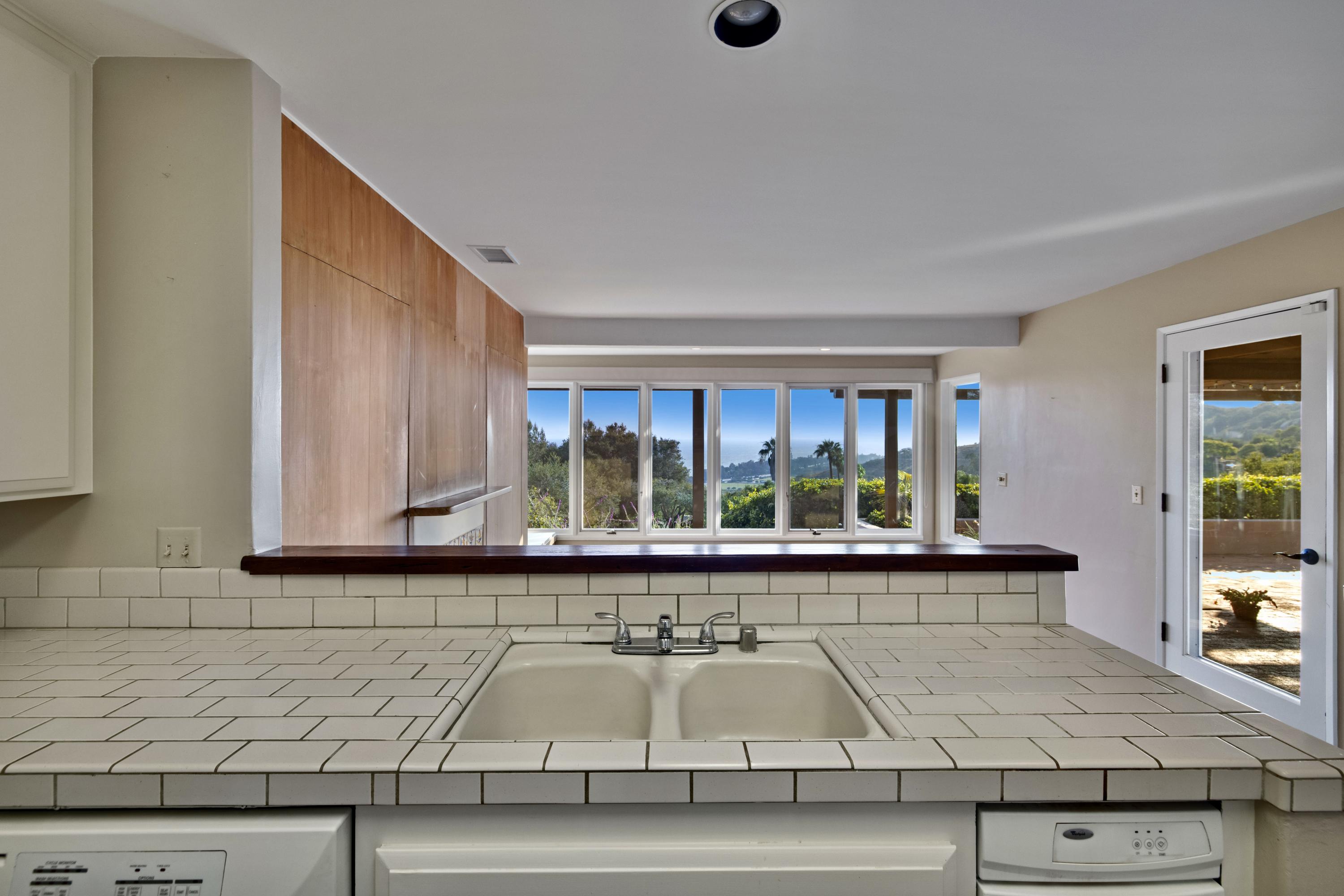1986 Arriba Street Carpinteria, CA 93013 - Photo 11 of 27 a living room with granite countertop kitchen island stainless steel appliances and a counter top space