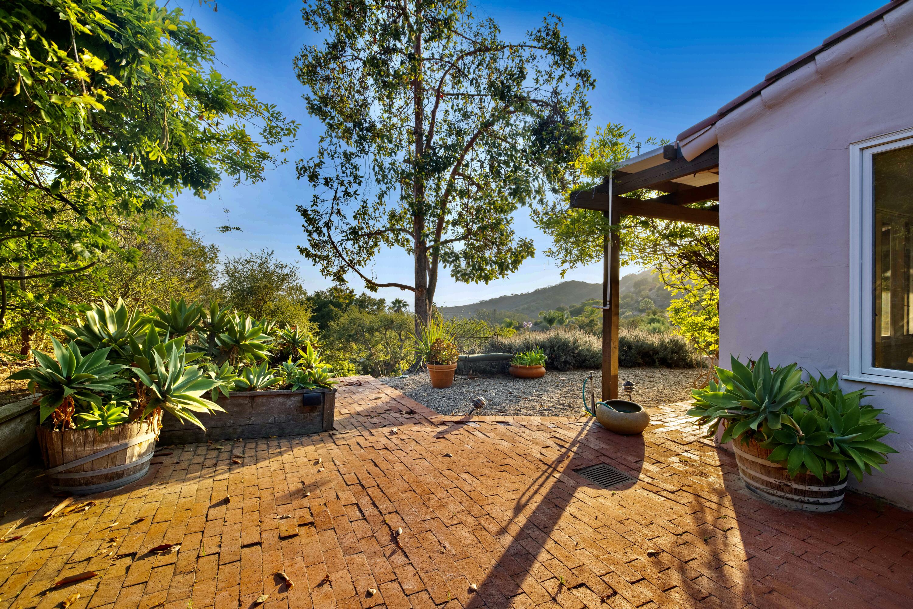 1986 Arriba Street Carpinteria, CA 93013 - Photo 22 of 27 a backyard of a house with outdoor seating
