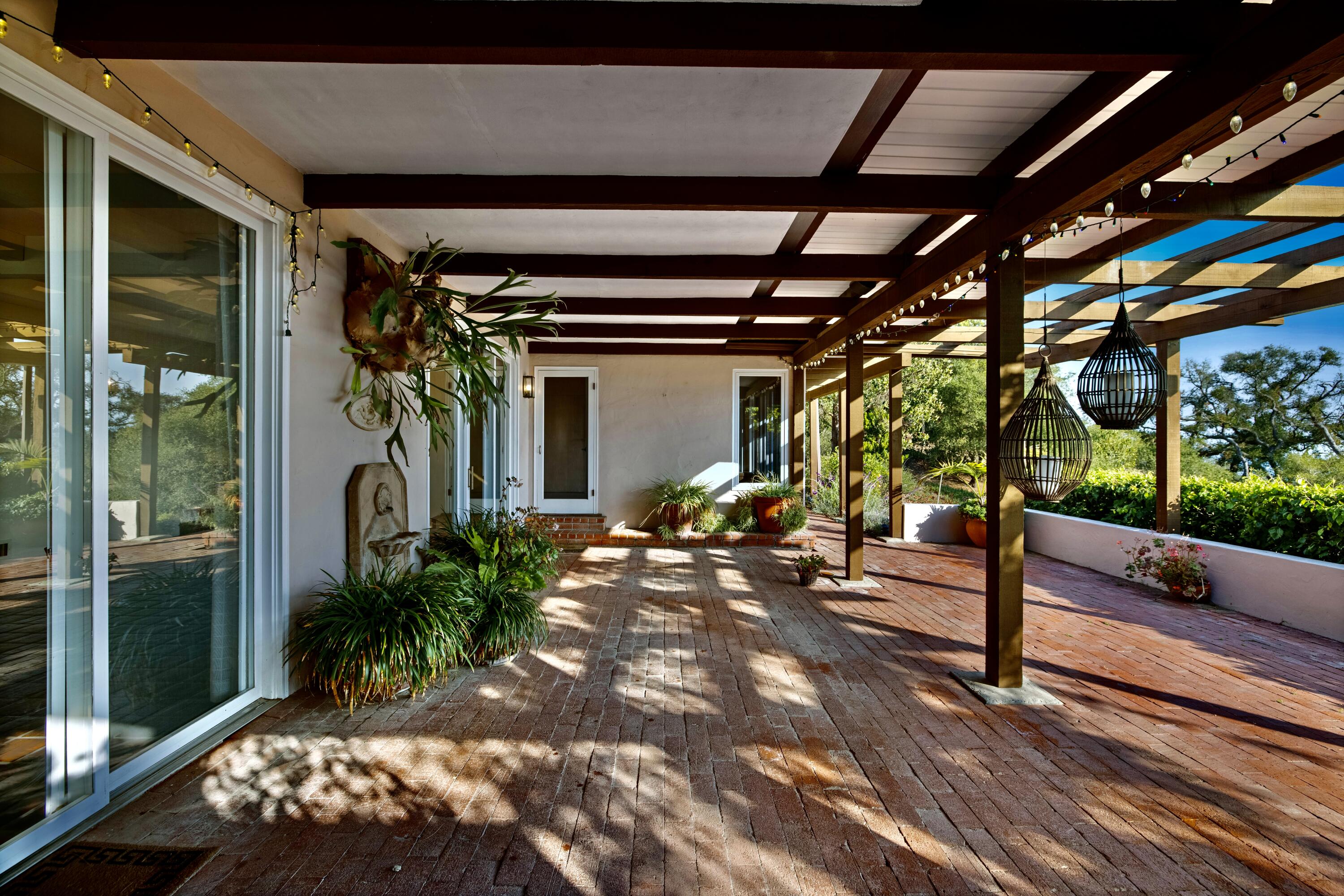 1986 Arriba Street Carpinteria, CA 93013 - Photo 9 of 27 a view of a porch with chairs and potted plants