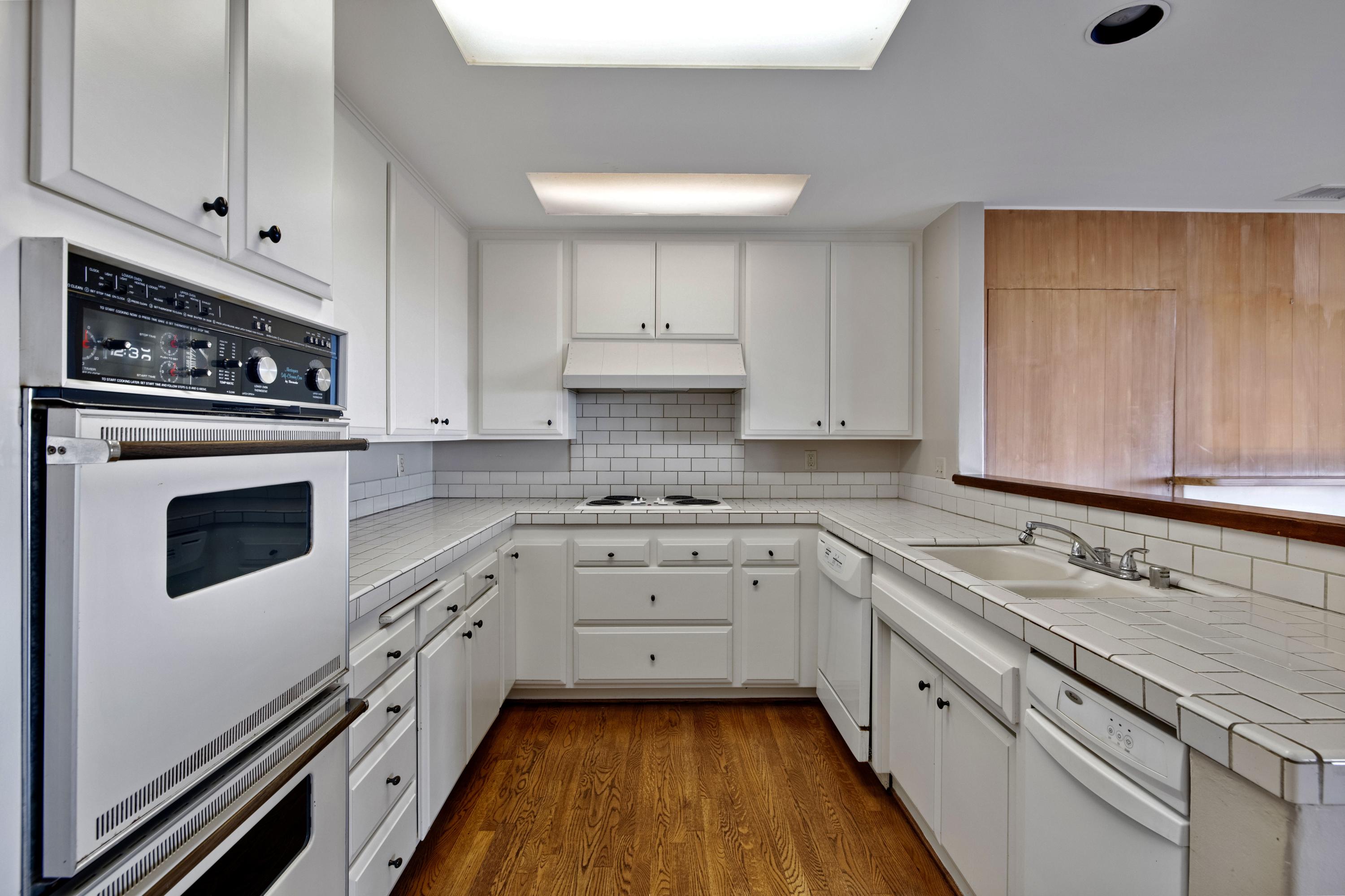 1986 Arriba Street Carpinteria, CA 93013 - Photo 10 of 27 a kitchen with granite countertop white cabinets and white appliances