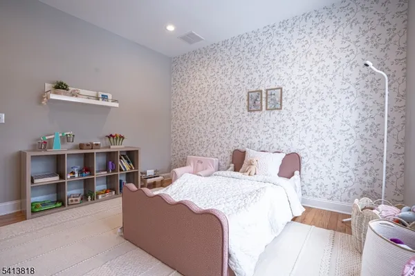a bedroom with a bed and a book shelf