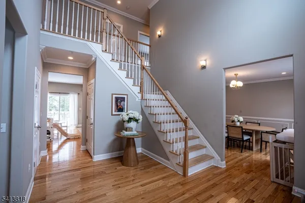 a view of entryway and hall with wooden floor