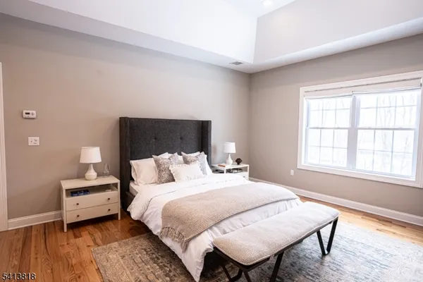 a bedroom with a bed and a night stand