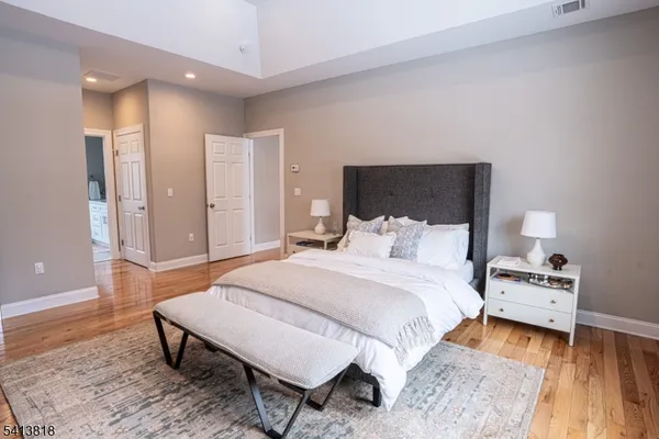 a bedroom with a bed and a night stand