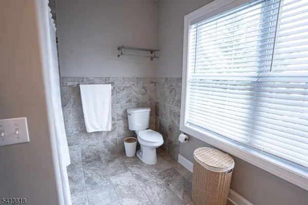 a white toilet sitting next to a bathroom sink
