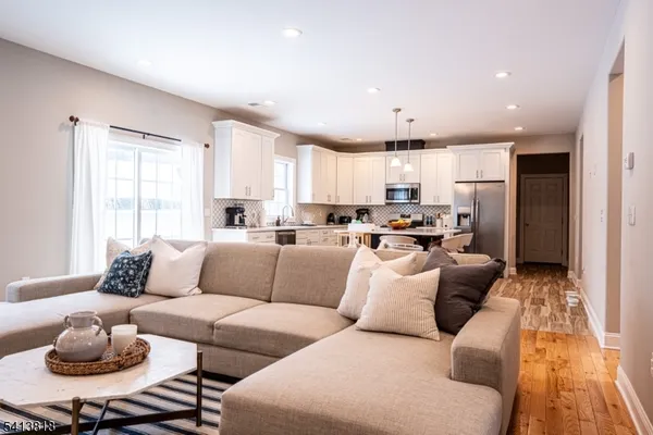 a living room with furniture and kitchen view