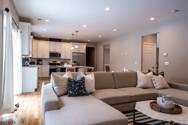 a living room with furniture and kitchen view