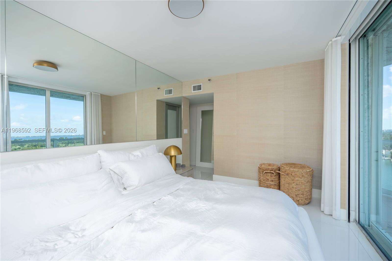 5900 Collins Avenue, Unit 1401 Miami Beach, FL 33140 - Photo 26 of 51 a bedroom with a bed and window