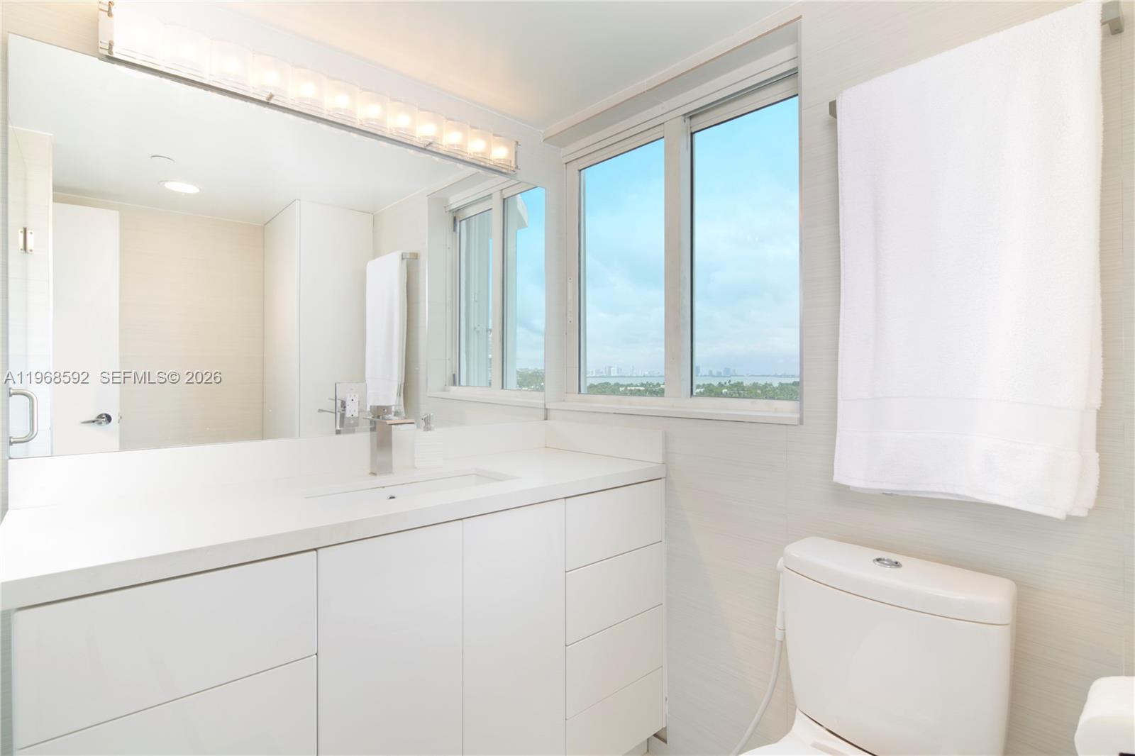 5900 Collins Avenue, Unit 1401 Miami Beach, FL 33140 - Photo 30 of 51 a bathroom with a sink and a mirror