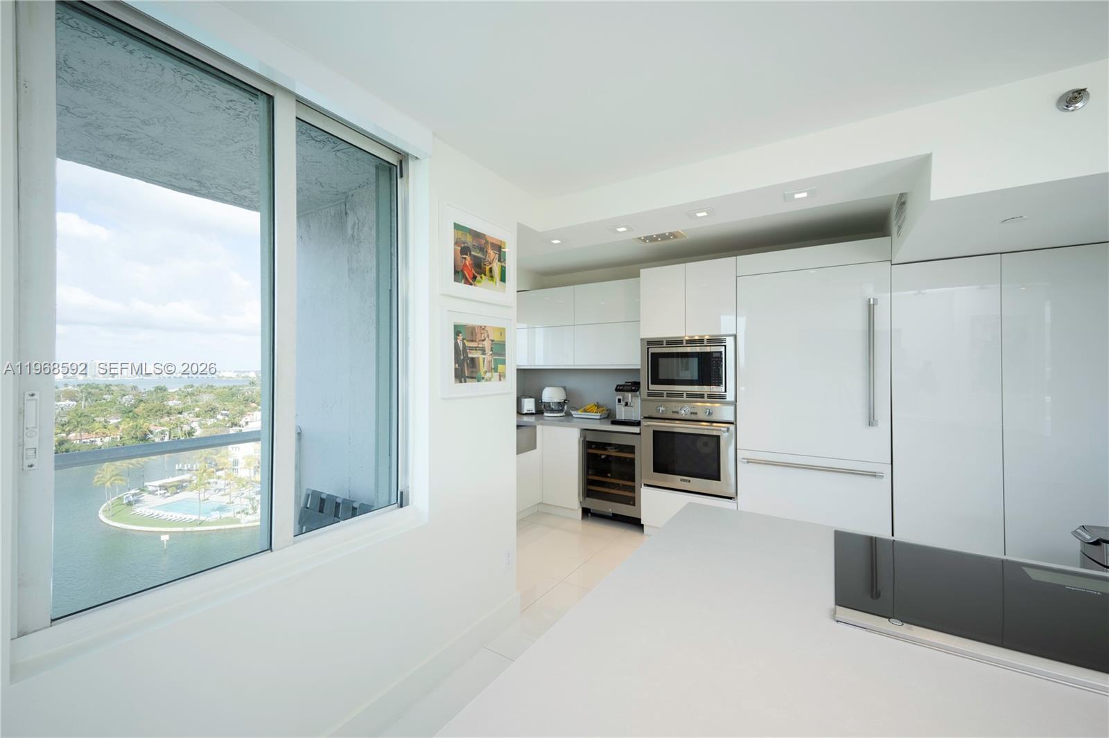5900 Collins Avenue, Unit 1401 Miami Beach, FL 33140 - Photo 3 of 51 a kitchen with stainless steel appliances a stove and a refrigerator