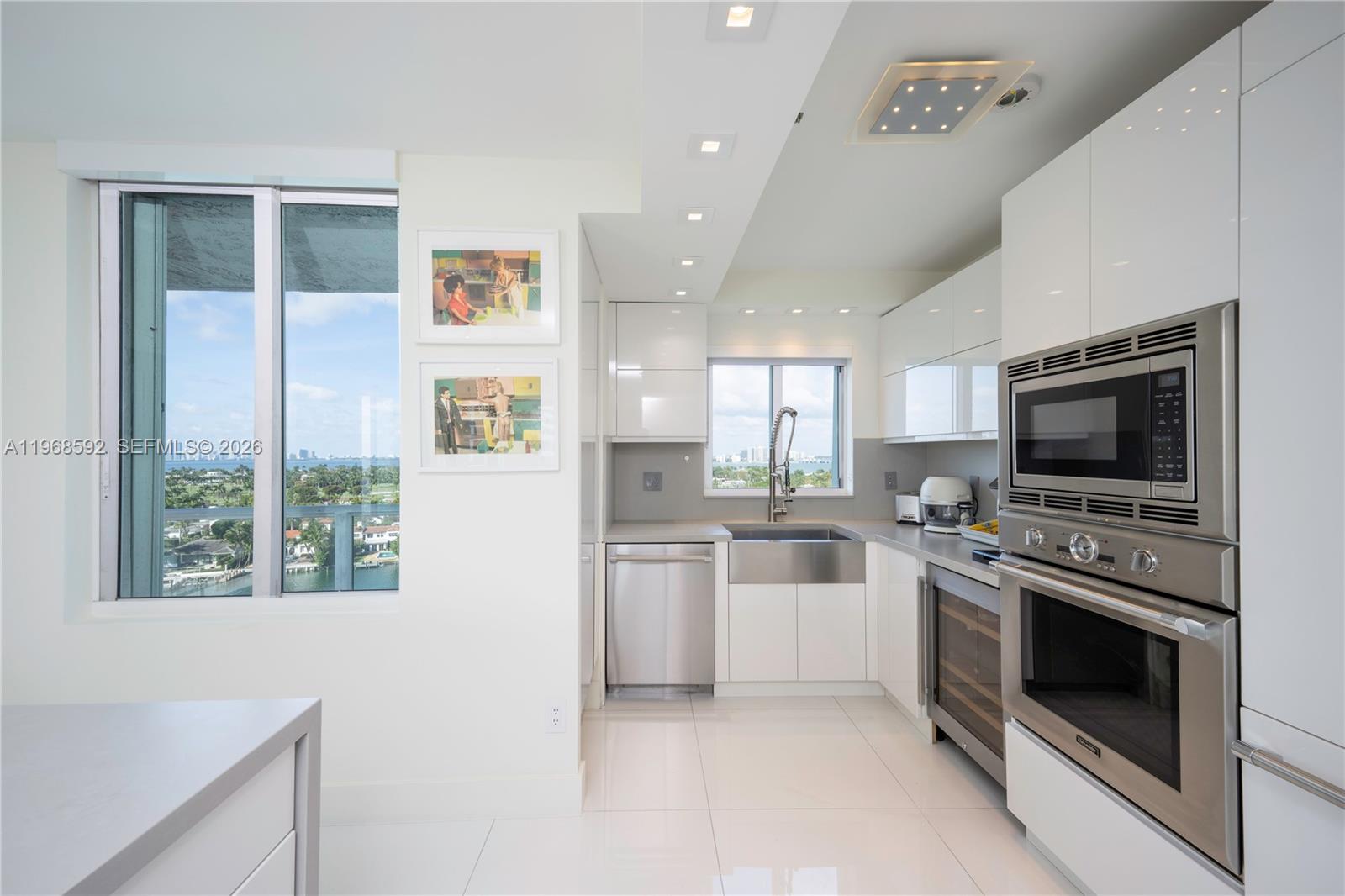 5900 Collins Avenue, Unit 1401 Miami Beach, FL 33140 - Photo 4 of 51 a kitchen with a stove top oven and refrigerator
