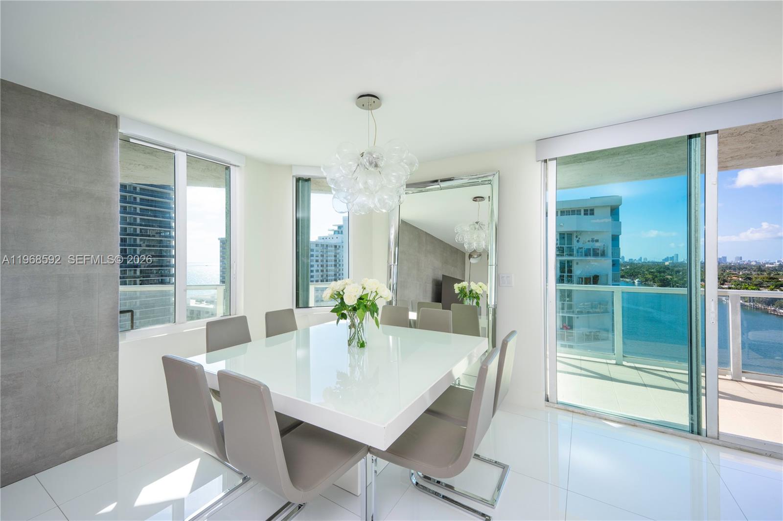 5900 Collins Avenue, Unit 1401 Miami Beach, FL 33140 - Photo 7 of 51 a dining room with furniture and window