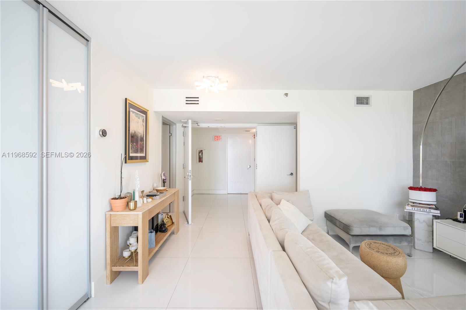 5900 Collins Avenue, Unit 1401 Miami Beach, FL 33140 - Photo 9 of 51 a bedroom with furniture and a view of bathroom