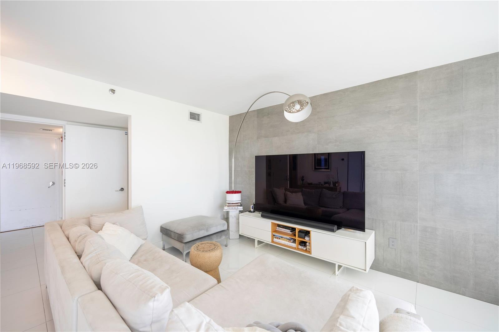 5900 Collins Avenue, Unit 1401 Miami Beach, FL 33140 - Photo 10 of 51 a living room with furniture and a flat screen tv