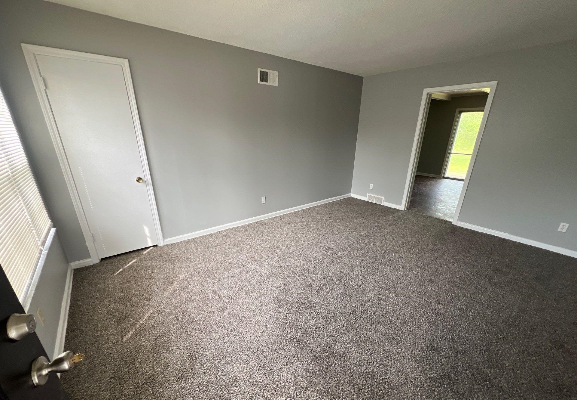 4936 Warrington Road Memphis, TN 38118 - Photo 8 of 13 an empty room with windows