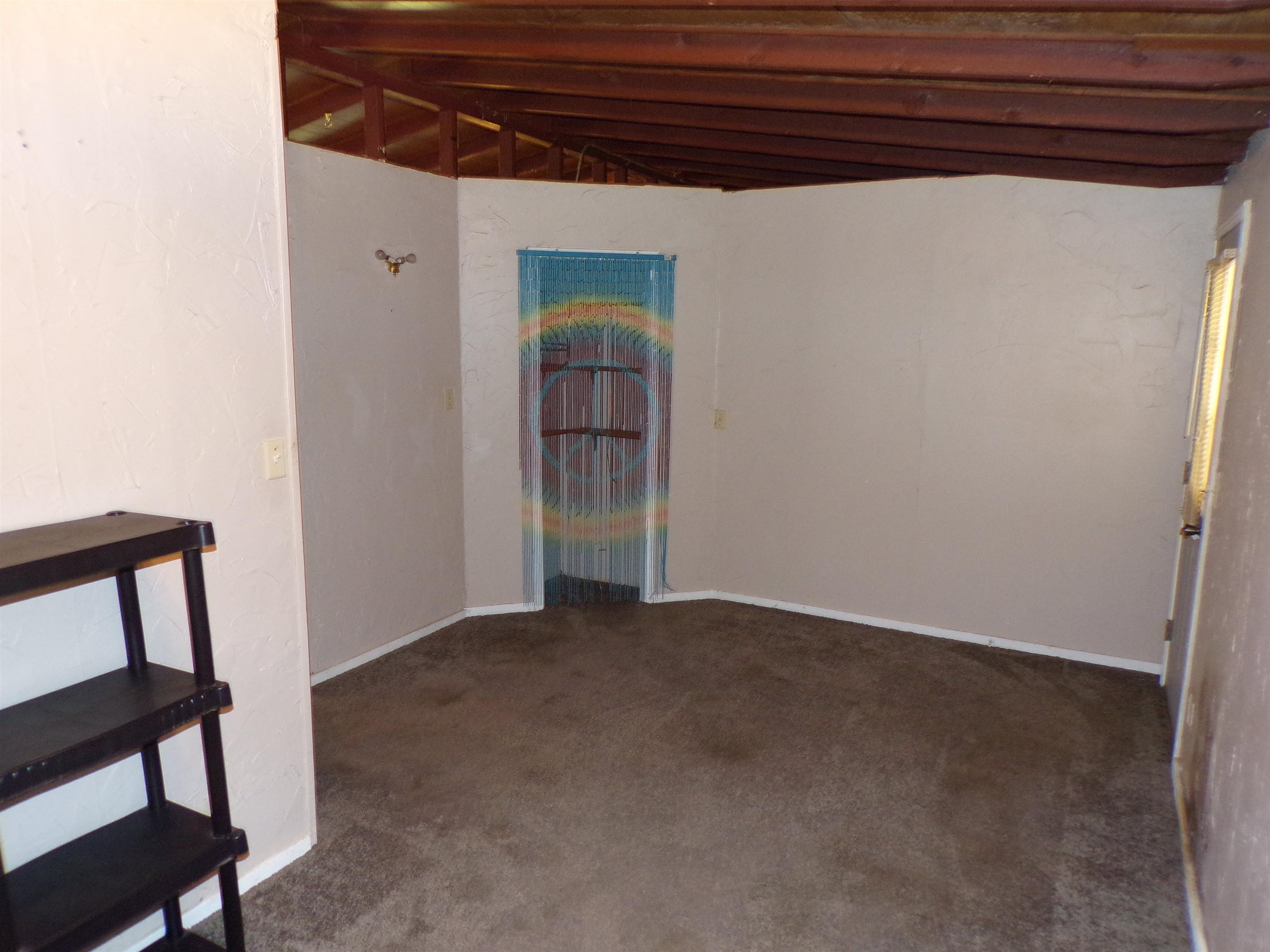 35 Cr 341 Road Iuka, MS 38852 - Photo 8 of 15 Carpeted interior space with exposed wood beam ceiling