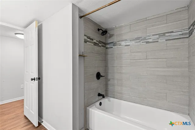 a bathroom with a bathtub and a shower