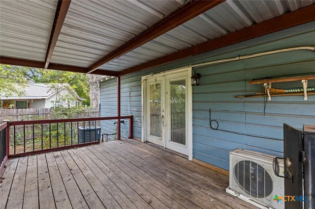 a view of a porch with wooden floor