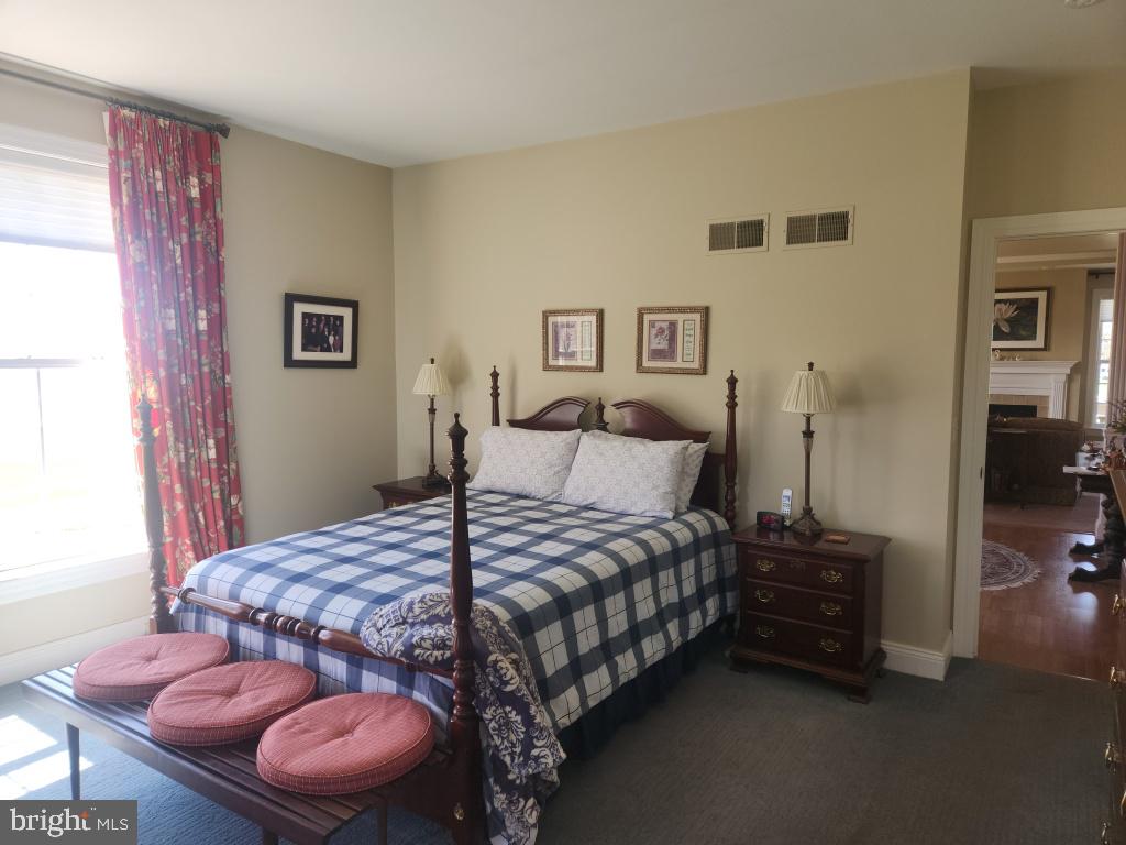 1043 Spring Valley Road Quarryville, PA 17566 - Photo 39 of 79 a bedroom with a bed and a chair