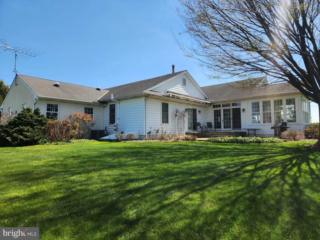1043 Spring Valley Road Quarryville, PA 17566 - Photo 4 of 79 a front view of a house with a garden