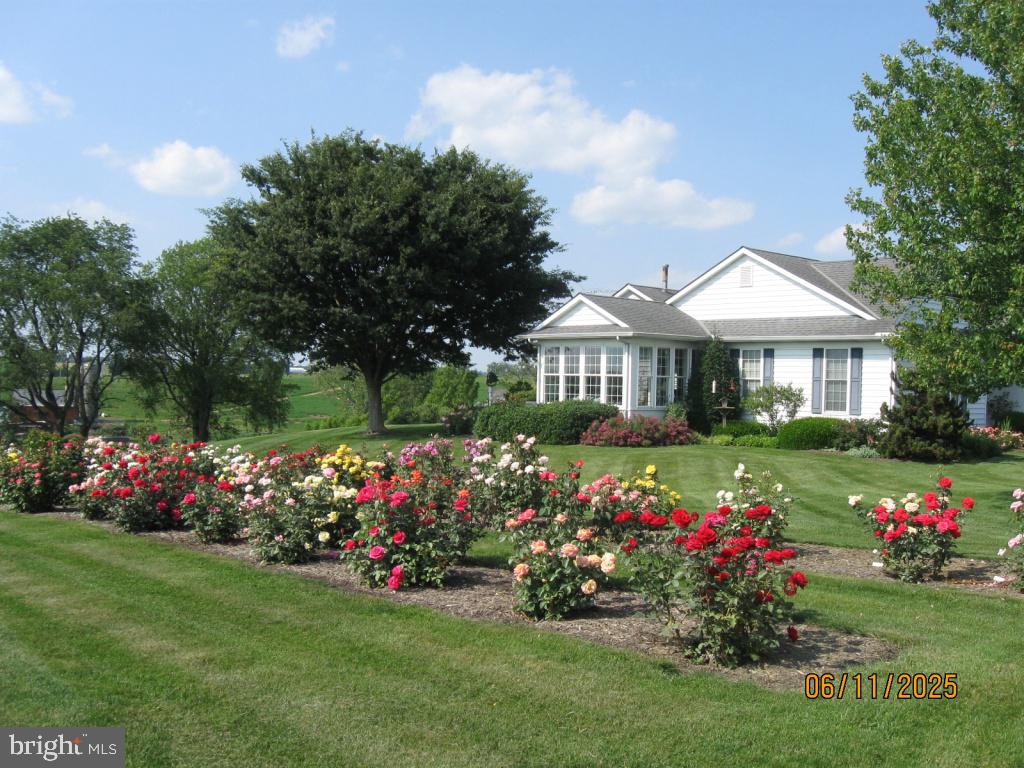 1043 Spring Valley Road Quarryville, PA 17566 - Photo 79 of 79 a front view of a house with a big yard and a garden
