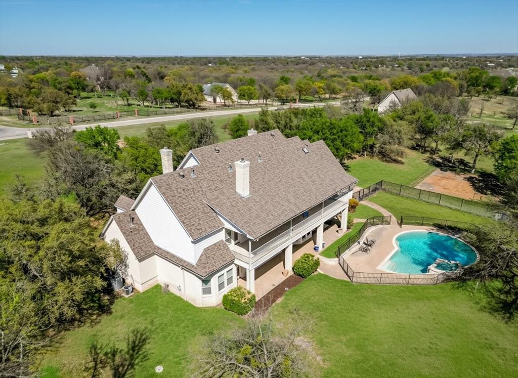 166 East Rio Ridge Azle, TX 76020 - Photo 1 of 40 an aerial view of a house with a yard and lake view