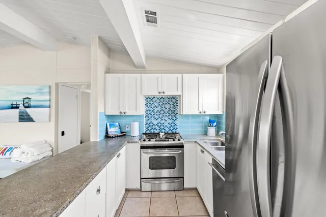 a kitchen with a refrigerator sink and stove