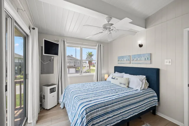 a bedroom with a large bed and a chandelier